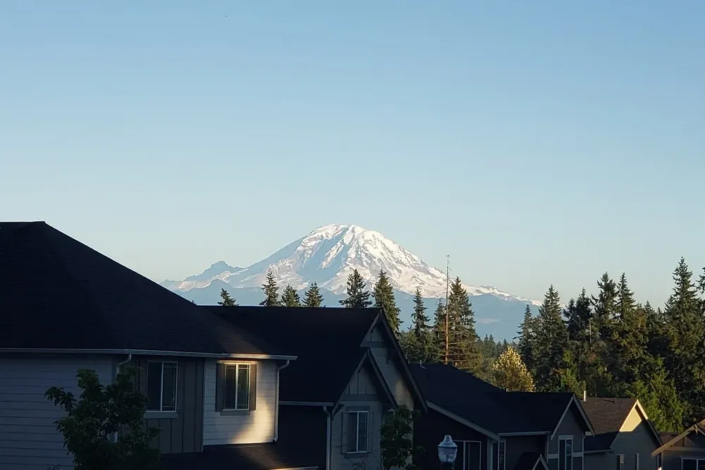 Mount Rainier rising above the rooftops of a residential neighborhood in Covington, Washington