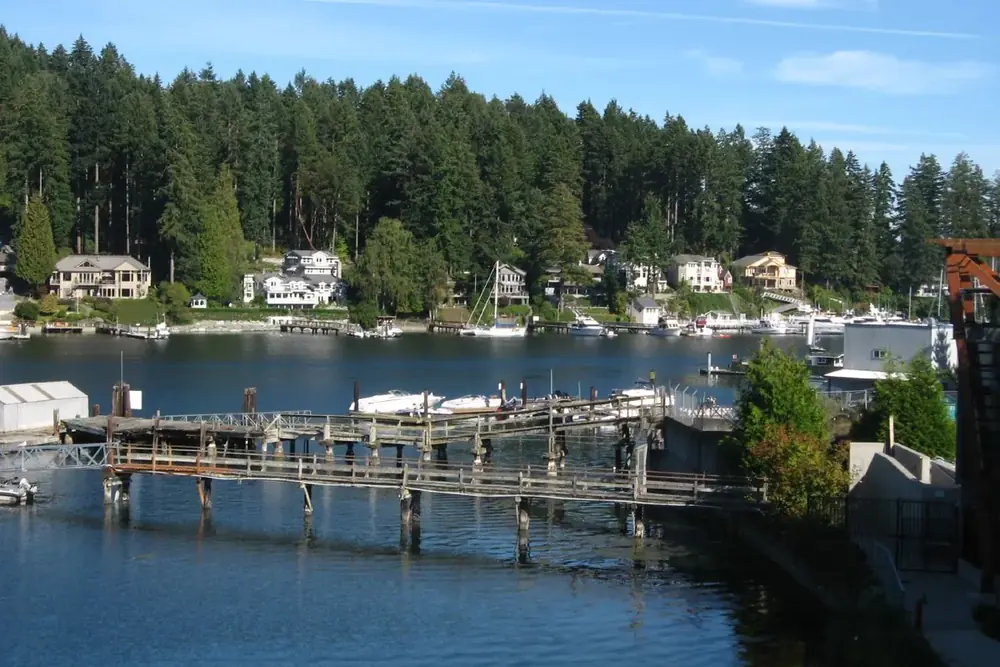 Wooden docks and a wooded shoreline along the harbor in Gig Harbor, Washington