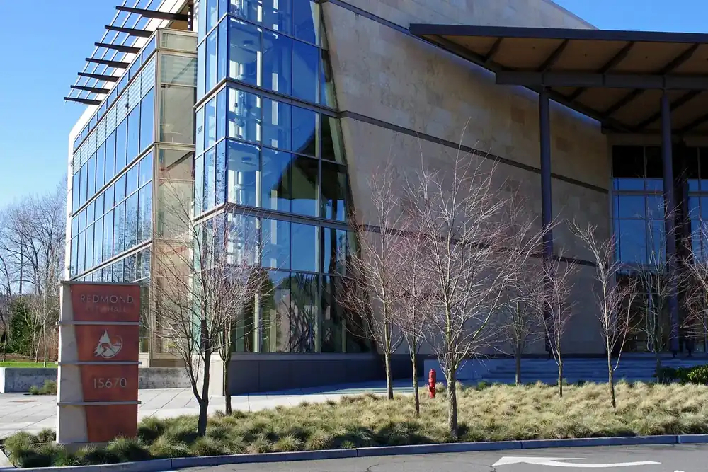 Glass and stone Redmond City Hall building with its entrance sign in Redmond, Washington